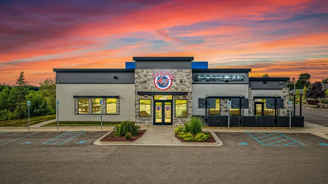 The Lansing restaurant at sunset, the sky pink behind the building