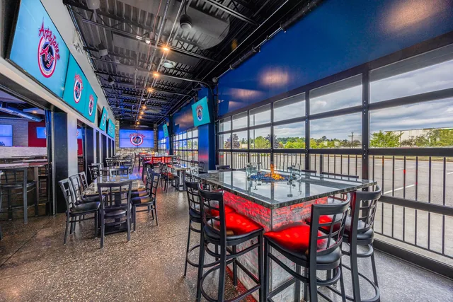 Lansing's covered patio, high-top seating open to the outside