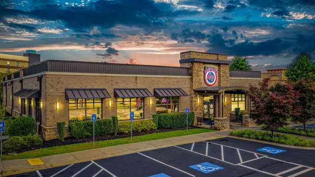 The Newnan restaurant at dusk, warm light spilling out of the entrance