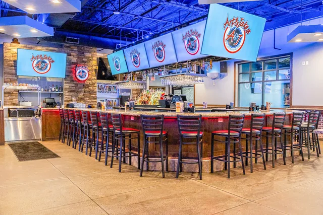 The long bar in Newnan, stools down its length and screens above