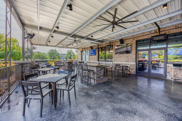 Newnan's open-air patio with the roll-up doors raised and fans turning