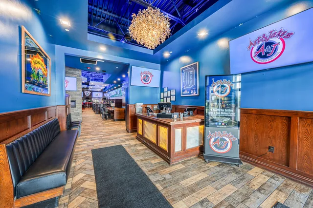 The Shelby Township bar in blue light, wood counter and a chandelier overhead