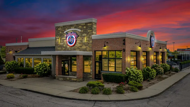 The Sterling Heights restaurant at sunset, the whole front lit up