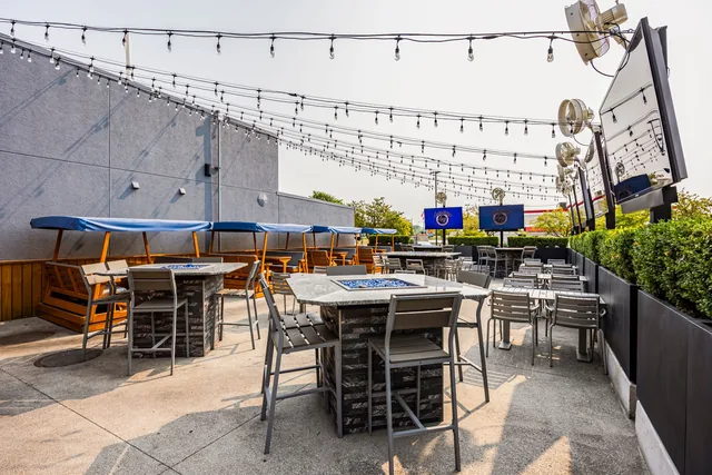 Sterling Heights' patio at dusk, strung lights over the tables